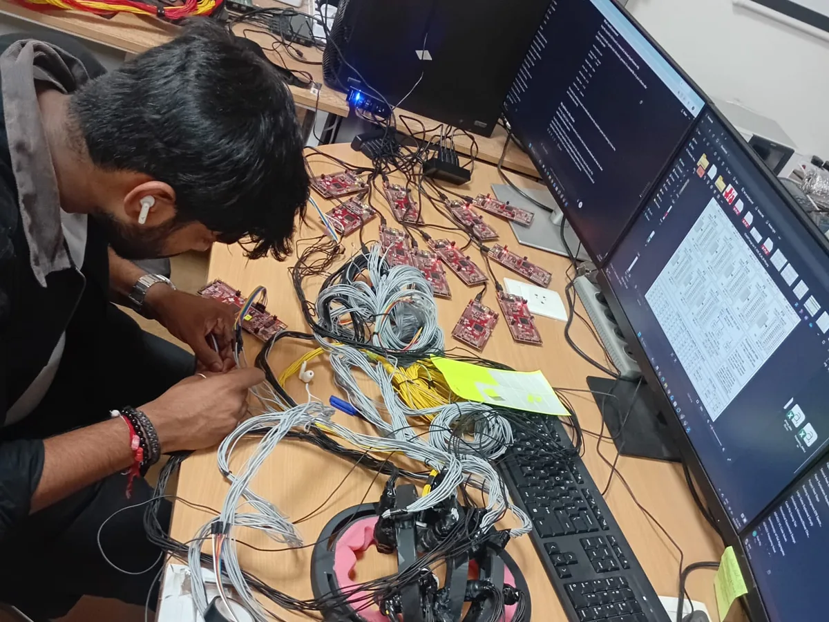 Researcher assembling and testing custom laboratory instrumentation