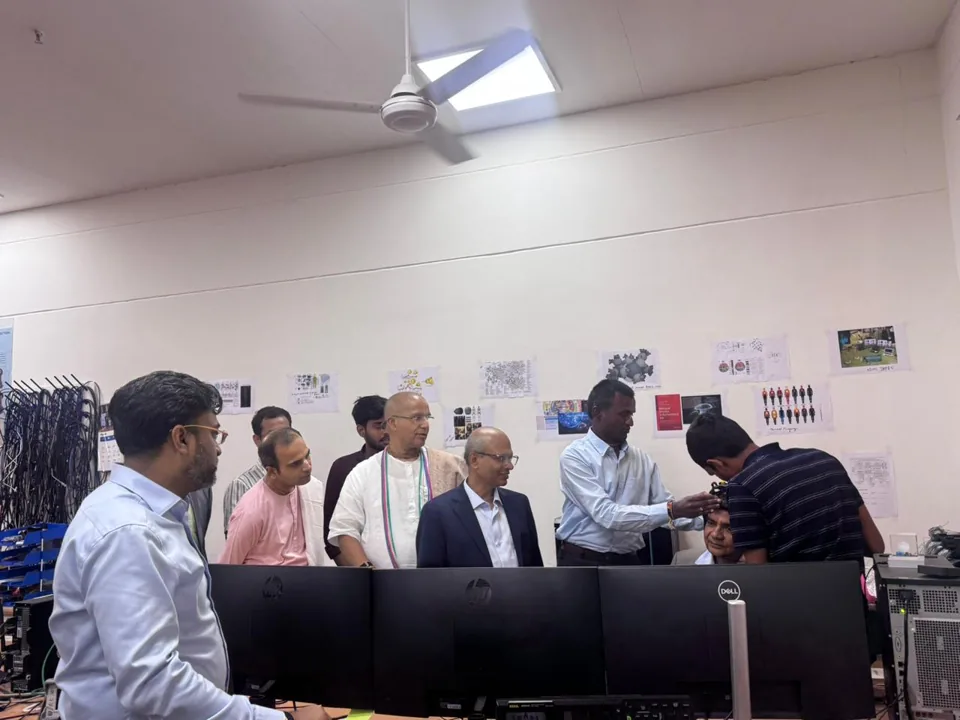 Visitors gathered around a laboratory workstation