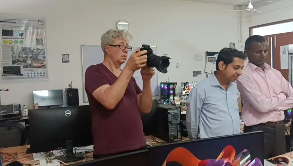Visitors photographing a laboratory demonstration